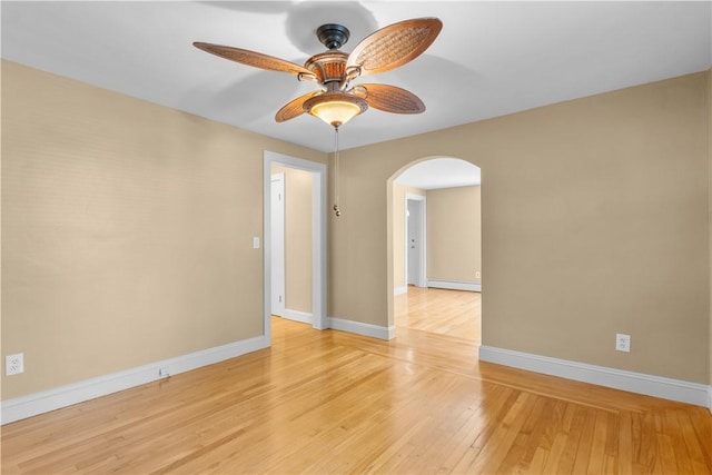 74 Park View Blvd, Cranston, RI 02910 - unfurnished room with arched walkways, a ceiling fan, light wood finished floors, and a baseboard heating unit