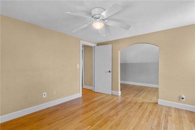 74 Park View Blvd, Cranston, RI 02910 - empty room with arched walkways, ceiling fan, and wood finished floors