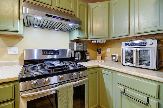 39 Old Onset Rd, Wareham, MA 02558 - kitchen with stainless steel gas stove, green cabinets, under cabinet range hood, and light countertops