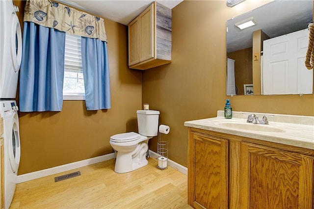 39 Old Onset Rd, Wareham, MA 02558 - bathroom with stacked washer and clothes dryer, vanity, and wood finished floors
