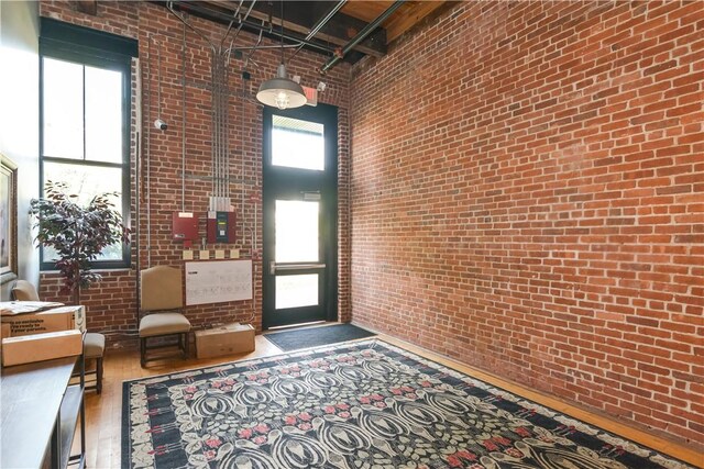 685 Social St Unit 103, Woonsocket, RI 02895 - foyer entrance featuring brick wall and a high ceiling
