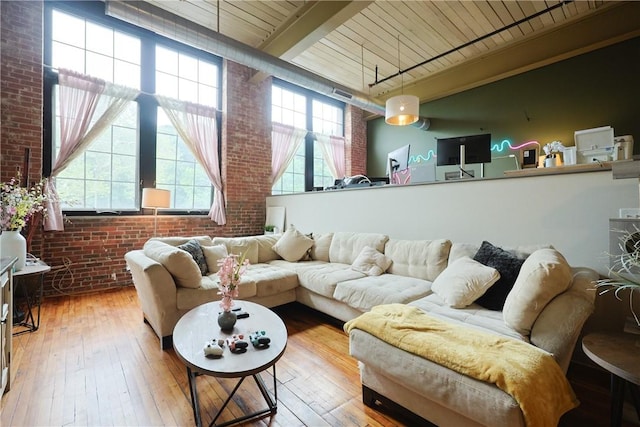 685 Social St Unit 103, Woonsocket, RI 02895 - living area featuring brick wall, a wood ceiling with exposed beams, and hardwood / wood-style floors