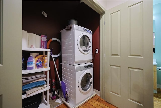 685 Social St Unit 103, Woonsocket, RI 02895 - washroom featuring estacked washer and dryer and wood finished floors