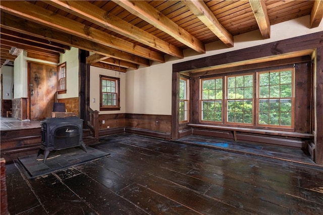 84 Skunk Hill Rd, Hopkinton, RI 02832 - unfurnished living room with wood-type flooring, wainscoting, a wooden ceiling with exposed beams, a wood stove, and wooden walls