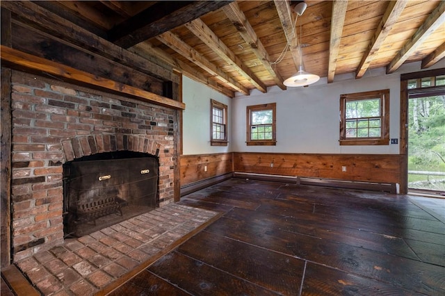 84 Skunk Hill Rd, Hopkinton, RI 02832 - unfurnished living room featuring a wood ceiling with exposed beams, a wainscoted wall, wood-type flooring, a brick fireplace, and wooden walls