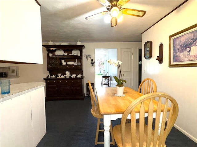 51 Old Carriage Rd, West Warwick, RI 02893 - dining room with ceiling fan and dark colored carpet