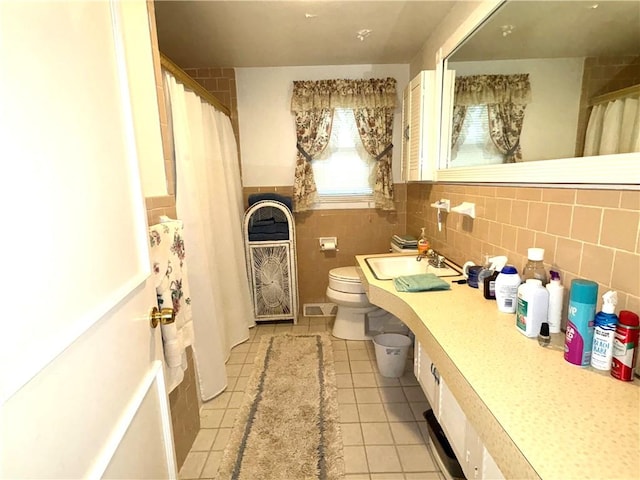 51 Old Carriage Rd, West Warwick, RI 02893 - full bath with tile patterned floors, tile walls, vanity, curtained shower, and wainscoting