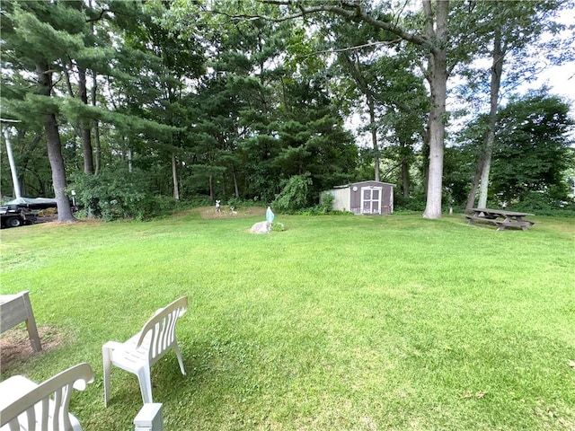 51 Old Carriage Rd, West Warwick, RI 02893 - view of grassy yard featuring a storage shed and view of wooded area