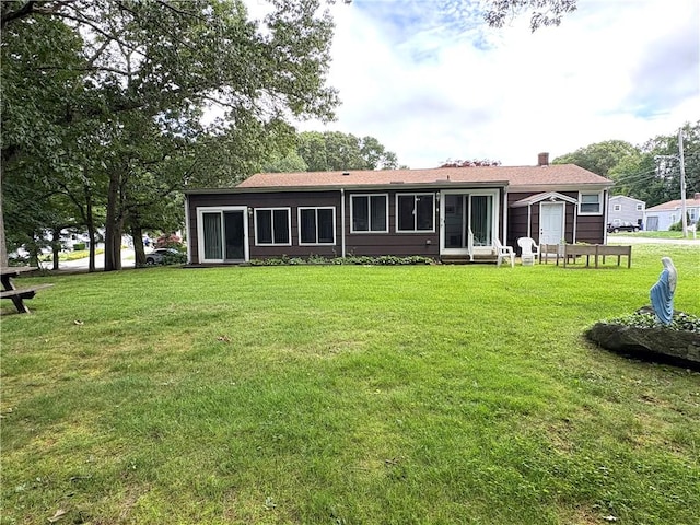 51 Old Carriage Rd, West Warwick, RI 02893 - back of property with a lawn and a chimney