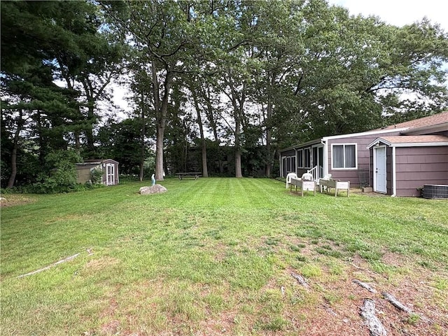 51 Old Carriage Rd, West Warwick, RI 02893 - view of green lawn with a shed and a sunroom