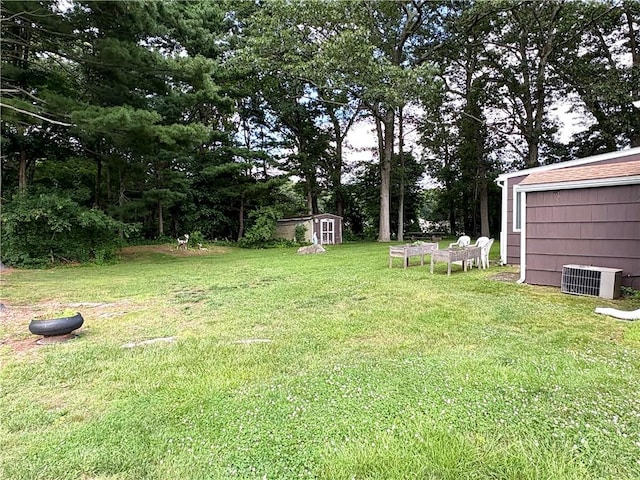 51 Old Carriage Rd, West Warwick, RI 02893 - view of green lawn with a shed and view of wooded area