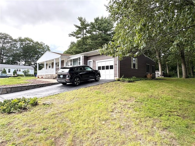 51 Old Carriage Rd, West Warwick, RI 02893 - view of side of home featuring a garage, driveway, and a lawn