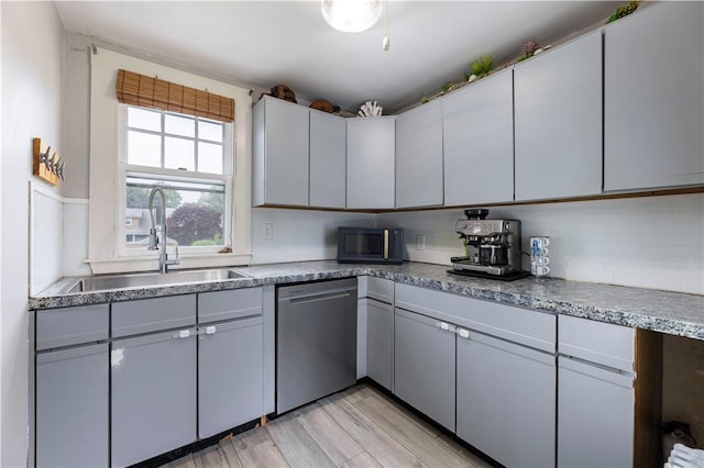 39 Chester Ave, Westerly, RI 02891 - kitchen with stainless steel dishwasher, black microwave, and light wood-style flooring