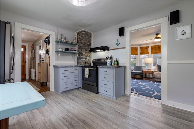 39 Chester Ave, Westerly, RI 02891 - kitchen featuring electric stove, exhaust hood, radiator heating unit, freestanding refrigerator, and light wood-style floors