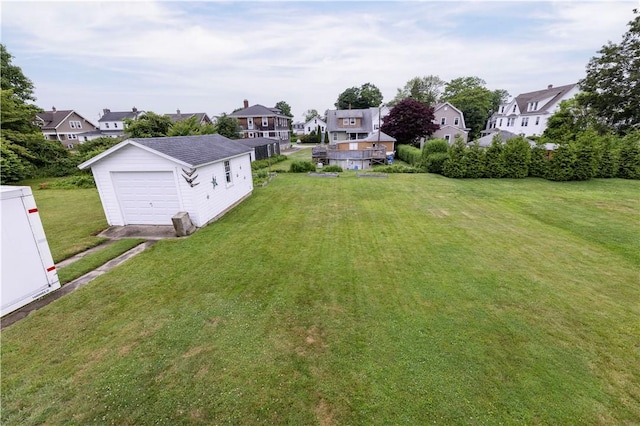 39 Chester Ave, Westerly, RI 02891 - view of green lawn with a residential view, an outbuilding, a garage, and driveway