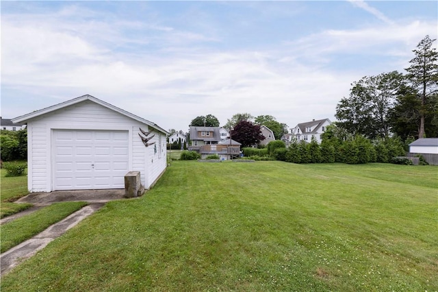 39 Chester Ave, Westerly, RI 02891 - view of grassy yard featuring a detached garage, an outbuilding, and driveway
