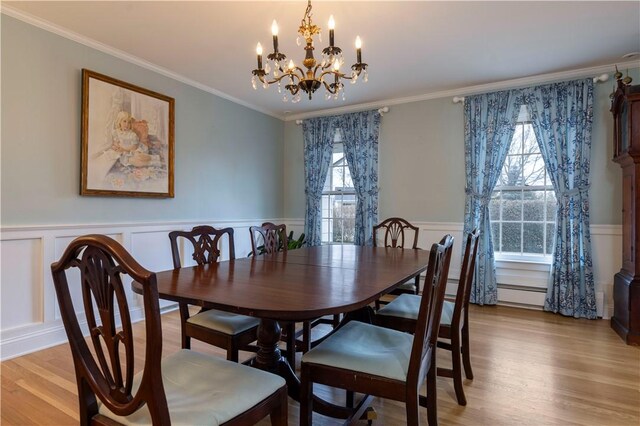 38 Setting Sun Dr, Westerly, RI 02891 - dining space with a chandelier, light wood-style flooring, a wainscoted wall, a decorative wall, and crown molding