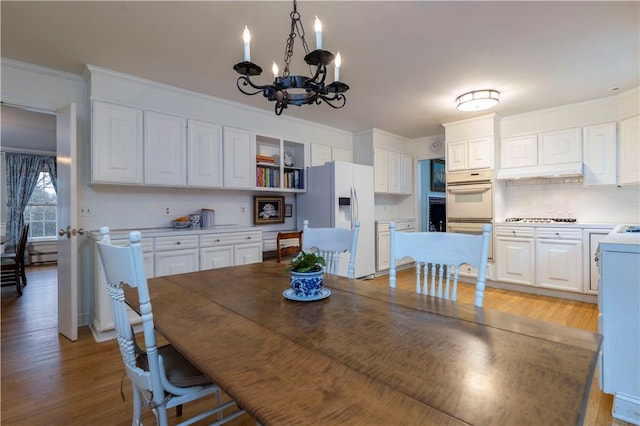 38 Setting Sun Dr, Westerly, RI 02891 - dining space with a chandelier, light wood-style flooring, and ornamental molding