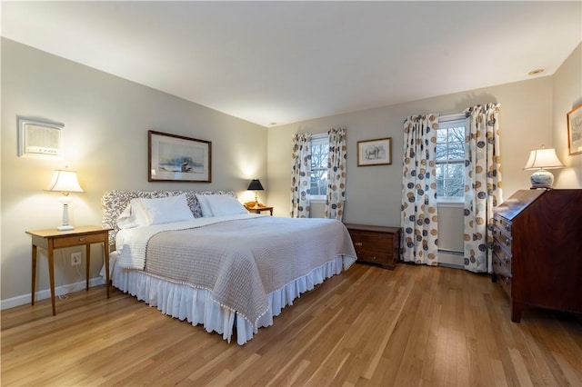38 Setting Sun Dr, Westerly, RI 02891 - bedroom featuring wood finished floors and a baseboard heating unit
