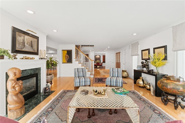 27 Eagle Dr, North Kingstown, RI 02852 - living area featuring stairs, wood finished floors, a premium fireplace, recessed lighting, and crown molding