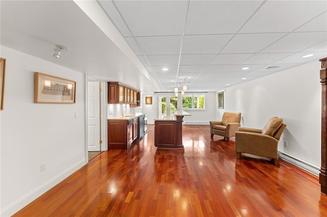 27 Eagle Dr, North Kingstown, RI 02852 - living room featuring a baseboard heating unit, dark wood-style flooring, recessed lighting, and a paneled ceiling