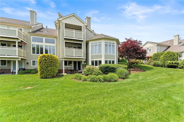 27 Eagle Dr, North Kingstown, RI 02852 - back of house featuring a yard and a chimney