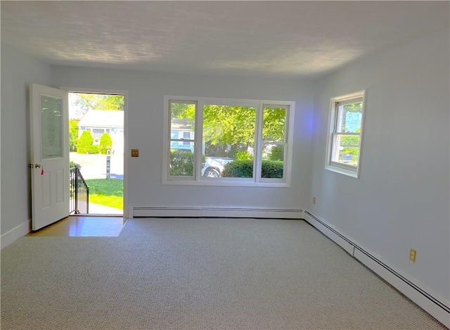10 Cavalier Rd, Narragansett, RI 02882 - carpeted empty room with baseboard heating and plenty of natural light