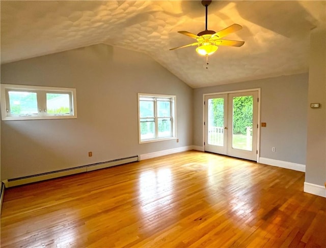 10 Cavalier Rd, Narragansett, RI 02882 - empty room featuring baseboard heating, a ceiling fan, wood finished floors, vaulted ceiling, and french doors