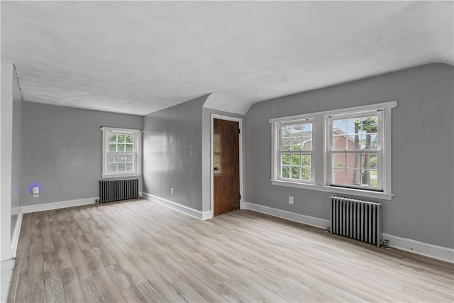 509 W Shore Rd, Warwick, RI 02889 - unfurnished room with radiator heating unit, wood finished floors, and vaulted ceiling