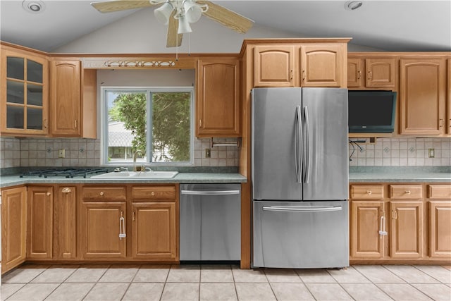 509 W Shore Rd, Warwick, RI 02889 - kitchen with stainless steel appliances, lofted ceiling, tasteful backsplash, glass insert cabinets, and light tile patterned floors