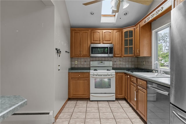 509 W Shore Rd, Warwick, RI 02889 - kitchen with appliances with stainless steel finishes, ceiling fan, backsplash, and glass insert cabinets
