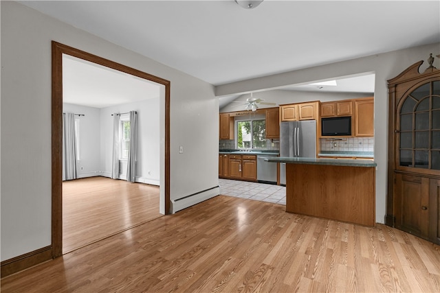 509 W Shore Rd, Warwick, RI 02889 - kitchen with appliances with stainless steel finishes, a baseboard heating unit, dark countertops, decorative backsplash, and light wood-style floors