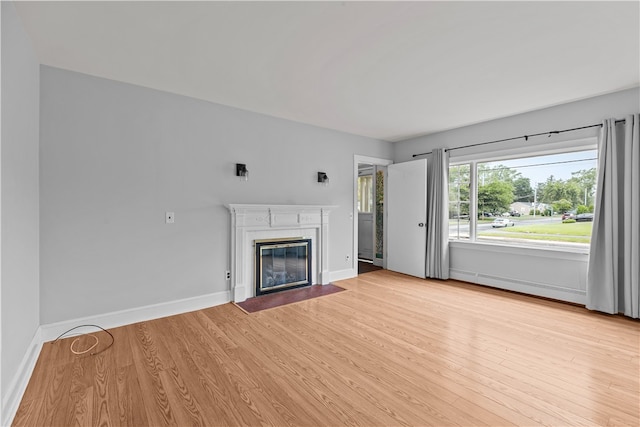 509 W Shore Rd, Warwick, RI 02889 - unfurnished living room featuring light wood-style floors and a fireplace with flush hearth