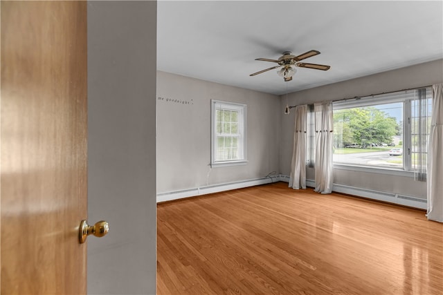 509 W Shore Rd, Warwick, RI 02889 - spare room featuring a baseboard heating unit, light wood-style flooring, and ceiling fan