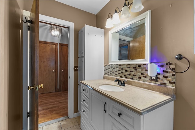 509 W Shore Rd, Warwick, RI 02889 - bathroom with backsplash, vanity, tile patterned floors, and a chandelier