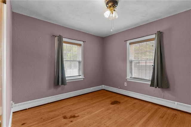 509 W Shore Rd, Warwick, RI 02889 - unfurnished room with wood finished floors, a ceiling fan, and a baseboard heating unit