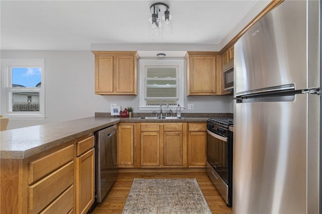 17 Victor Emanuel Ave, Providence, RI 02904 - kitchen with stainless steel appliances, a peninsula, and light wood-type flooring