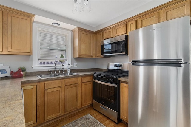 17 Victor Emanuel Ave, Providence, RI 02904 - kitchen featuring appliances with stainless steel finishes, light wood finished floors, and brown cabinets