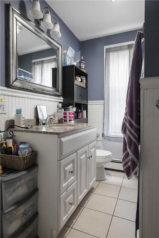10 Sylvan Ave, Cranston, RI 02905 - bathroom with wainscoting, tile patterned floors, vanity, and a baseboard radiator