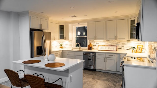 945 Danielson Pike, Scituate, RI 02857 - kitchen featuring appliances with stainless steel finishes, light countertops, decorative backsplash, glass insert cabinets, and a breakfast bar