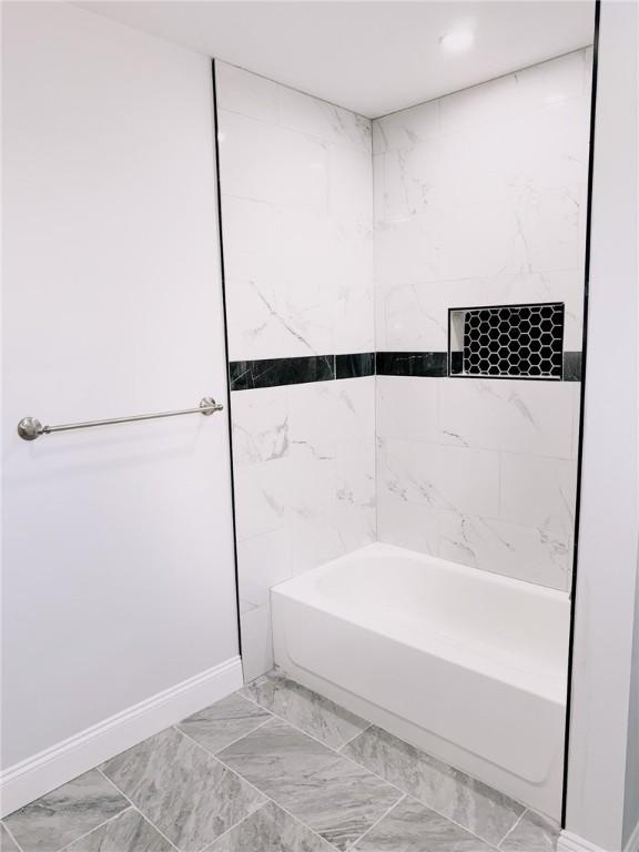 945 Danielson Pike, Scituate, RI 02857 - bathroom with shower / bathtub combination and marble look tile flooring