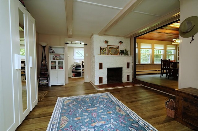 318 Saint Paul St, North Smithfield, RI 02896 - living area featuring a baseboard heating unit, wood finished floors, beam ceiling, a barn door, and a fireplace