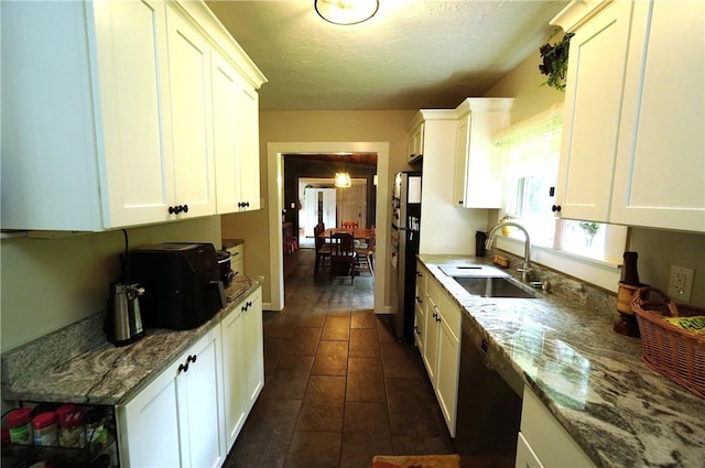 318 Saint Paul St, North Smithfield, RI 02896 - kitchen with dishwashing machine, freestanding refrigerator, white cabinets, and a textured ceiling