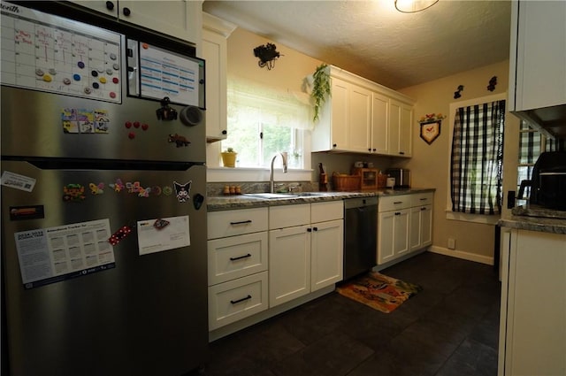 318 Saint Paul St, North Smithfield, RI 02896 - kitchen featuring freestanding refrigerator, dishwasher, white cabinetry, dark countertops, and a textured ceiling