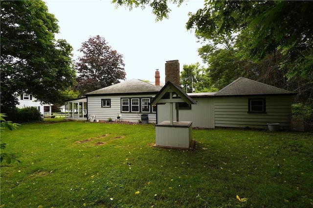 318 Saint Paul St, North Smithfield, RI 02896 - rear view of house with a chimney and a lawn