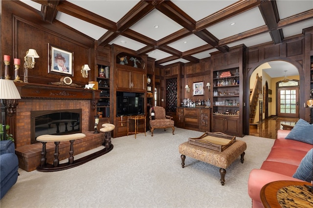 17 Pojac Point Rd, North Kingstown, RI 02852 - carpeted living area featuring coffered ceiling, a bar, arched walkways, beam ceiling, and a fireplace