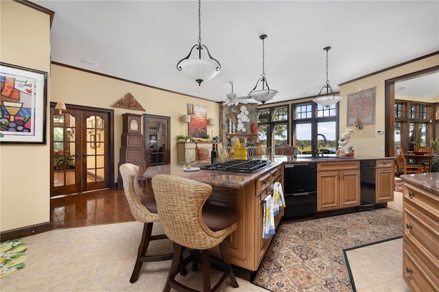 17 Pojac Point Rd, North Kingstown, RI 02852 - kitchen featuring stainless steel gas stovetop, french doors, ornamental molding, a breakfast bar area, and pendant lighting