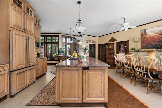 17 Pojac Point Rd, North Kingstown, RI 02852 - kitchen with paneled built in fridge, a kitchen island, french doors, a ceiling fan, and glass insert cabinets