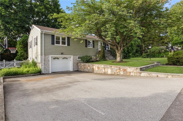 25 Rosewood Dr, North Providence, RI 02904 - view of front of home featuring asphalt driveway, stone siding, a garage, and stairs