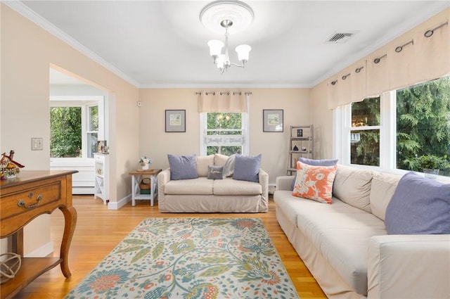 25 Rosewood Dr, North Providence, RI 02904 - living area featuring healthy amount of natural light, crown molding, a chandelier, light wood-style flooring, and a baseboard radiator